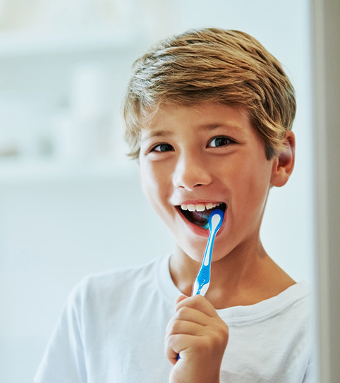 a young boy brushing his teeth