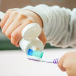 dr jennifer lee dentist advises to use fluoride based toothpaste on toothbrush